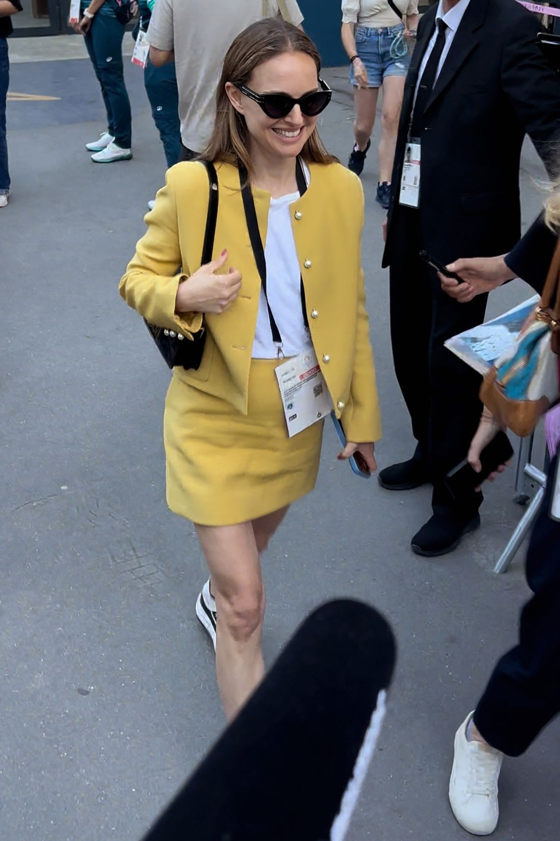 Actor Natalie Portman was seen in a mustard yellow mini skirt suit leaving the Olympics grounds on July 30.