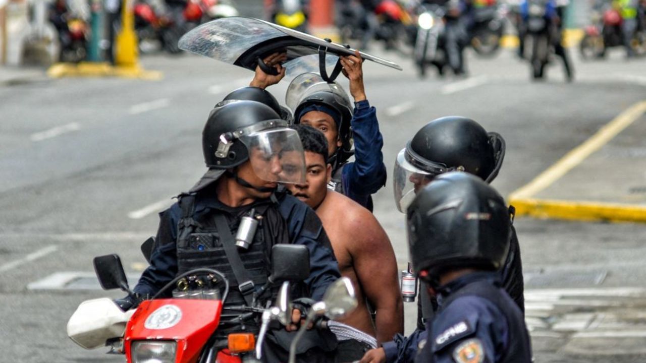 of the National Police detain a man during a demonstration called by the opposition in Chacao neighbourhood in Caracas on July 30, 2024. Security forces fired tear gas and rubber bullets at protesters and an NGO said 11 people have been killed, dozens more were injured during the aftermath of the Venezuelan presidential election. On July 30, 2024, President Nicolas Maduro said the opposition would be held responsible for "criminal violence". (Photo by Juan Calero / AFP) (Photo by JUAN CALERO/AFP via Getty Images)