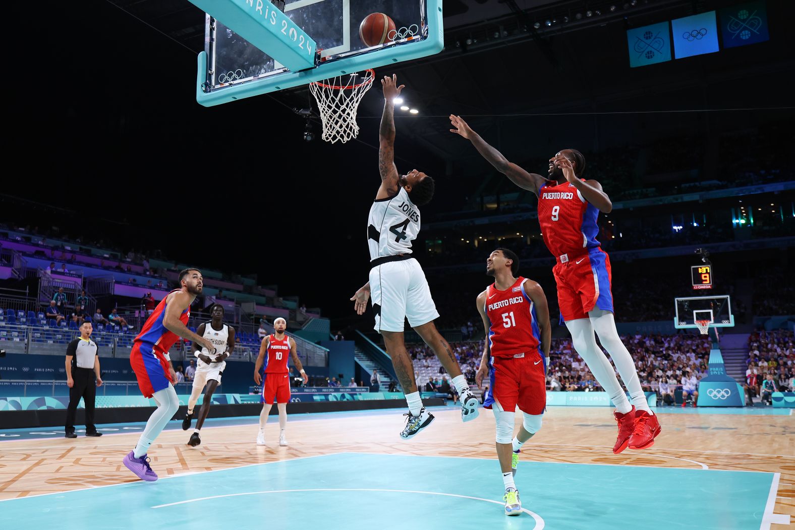 South Sudanese basketball player Carlik Jones drives to the basket during a game against Puerto Rico on July 28. South Sudan claimed a <a >historic victory</a> in its first-ever Olympic men's game, winning 90-79.