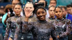 PARIS, FRANCE - JULY 28: Simone Biles of Team United States waves as she is joined by members of Team United States following Subdivision 2 during the Artistic Gymnastics Women's Qualification on day two of the Olympic Games Paris 2024 at Bercy Arena on July 28, 2024 in Paris, France. (Photo by Ezra Shaw/Getty Images)