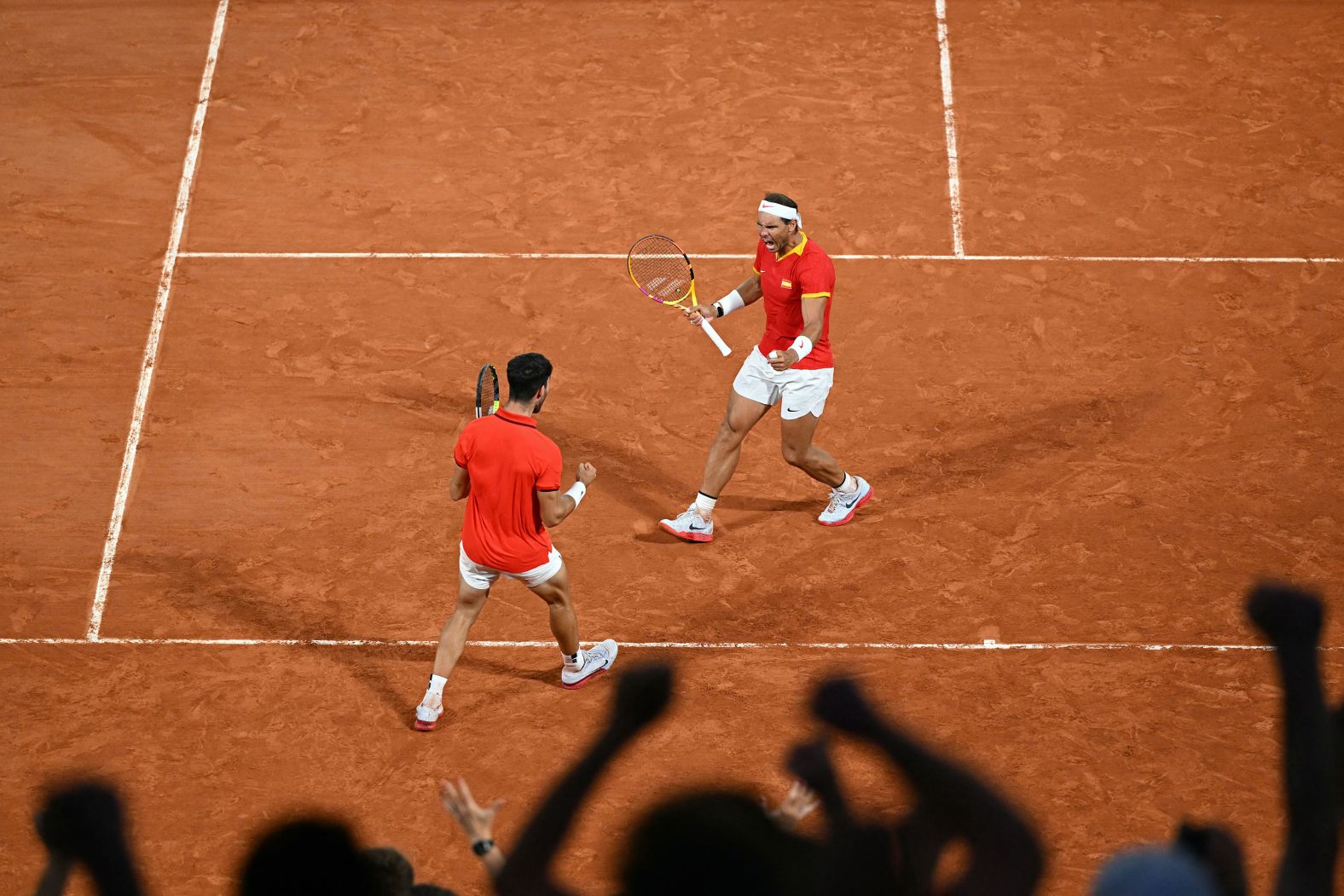 Nadal and Spain's Carlos Alcaraz react while playing a doubles match at the Paris Olympics in July 2024.