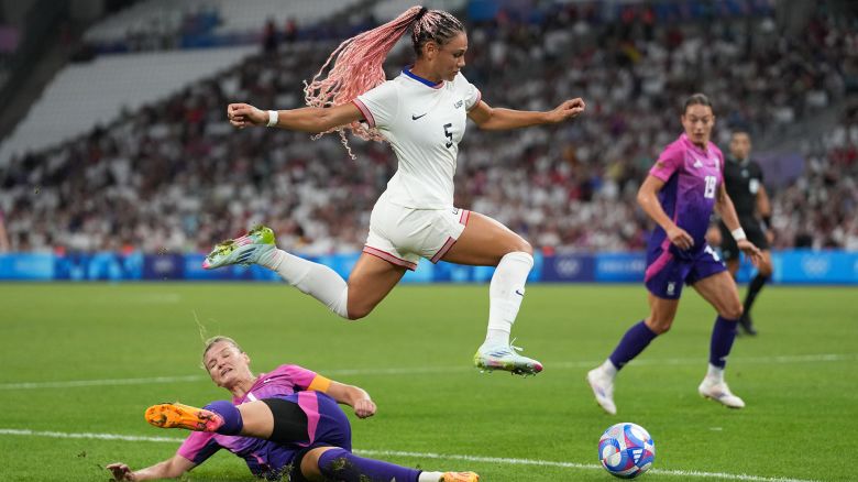 MARSEILLE, FRANCE - JULY 28: Trinity Rodman #5 of the United States jumps over the tackle of Alexandra Popp #11 of Germany during the first half of the Women's group B match during the Olympic Games Paris 2024 at Stade de Marseille on July 28, 2024 in Marseille, France. (Photo by Brad Smith/ISI/Getty Images)