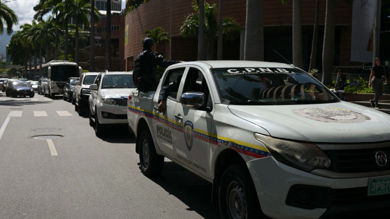 Officers of the Bolivarian National Police escort cars transporting of the Argentina's diplomat body in Venezuela as they leave Argentina's embassy in Caracas on August 1, 2024. The Argentine government on July 30, 2024, complained of "harassment" at its embassy in Venezuela, a day after President Nicolas Maduro's government ordered a slew of South American diplomats to leave Caracas for questioning his election win. (Photo by YURI CORTEZ / AFP) (Photo by YURI CORTEZ/AFP via Getty Images)