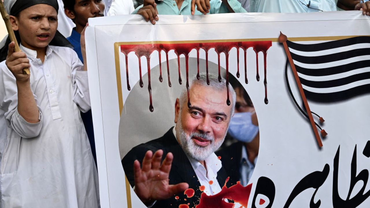 Activists and supporters of Jamiat Ulema-e-Islam (F) party take part in a protest in Lahore on August 2, 2024, against the assassination of Hamas chief Ismail Haniyeh in an air strike in Tehran. Pakistan said on July 31 the killing of Hamas's political leader in an air strike in neighbouring Iran blamed on Israel was a "reckless act", while hundreds of supporters of an Islamist party held a symbolic funeral near Islamabad. (Photo by Arif ALI / AFP) (Photo by ARIF ALI/AFP via Getty Images)