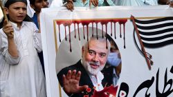 Activists and supporters of Jamiat Ulema-e-Islam (F) party take part in a protest in Lahore on August 2, 2024, against the assassination of Hamas chief Ismail Haniyeh in an air strike in Tehran. Pakistan said on July 31 the killing of Hamas's political leader in an air strike in neighbouring Iran blamed on Israel was a "reckless act", while hundreds of supporters of an Islamist party held a symbolic funeral near Islamabad. (Photo by Arif ALI / AFP) (Photo by ARIF ALI/AFP via Getty Images)