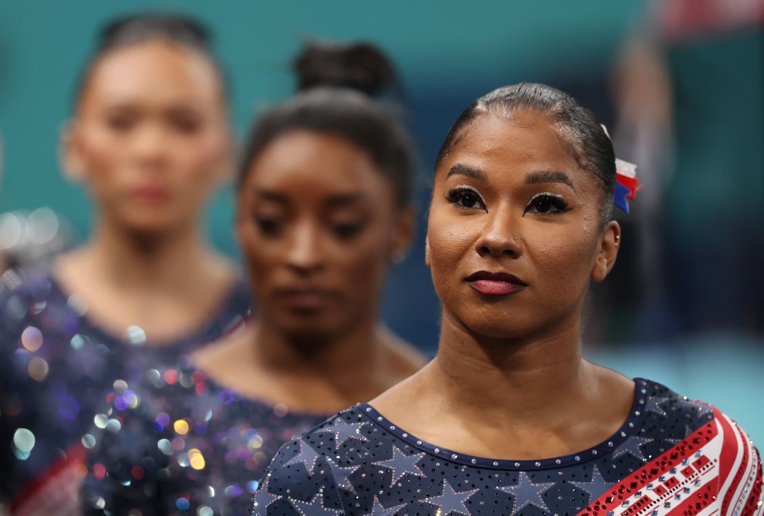 Jordan Chiles, with Simone Biles behind her, watches the competition during the women's team gymnastics final of the 2024 Paris Olympics.