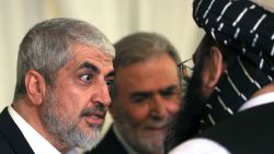 Mourners offer their condolences to senior Hamas official Khaled Meshaal (L) and Ziyad al-Nakhalah, (C) Secretary-General of the Palestinian Islamic Jihad movement during the funeral of the slain Hamas political leader, in the Qatari capital Doha on August 2, 2024. Hamas leader Ismail Haniyeh was buried in Qatar on August 2 after his killing in Tehran, an attack blamed on Israel that has heightened regional tensions as the Gaza war dragged on. The Palestinian armed group's political chief played a key role in mediated talks aimed at ending nearly 10 months of war between Hamas and Israel in Gaza. (Photo by Mahmud Hams / AFP) (Photo by MAHMUD HAMS/AFP via Getty Images)