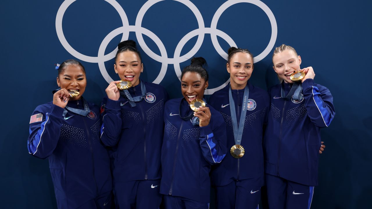 PARIS, FRANCE - JULY 30: (L-R) Gold medalists Jordan Chiles, Sunisa Lee, Simone Biles, Hezly Rivera and Jade Carey of Team United States pose with the Olympic Rings during the medal ceremony for the Artistic Gymnastics Women's Team Final on day four of the Olympic Games Paris 2024 at Bercy Arena on July 30, 2024 in Paris, France. (Photo by Naomi Baker/Getty Images)