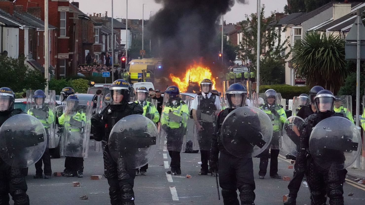 Riot police hold back protesters after disorder broke out on July 30, 2024, in Southport, England. Rumors about the identity of the 17-year-old suspect in a deadly stabbing attack sparked a violent protest.