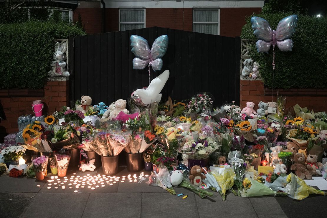 Tributes and candles to the victims of the Southport knife attack laid near the scene on July 30, 2024 in Southport, England.