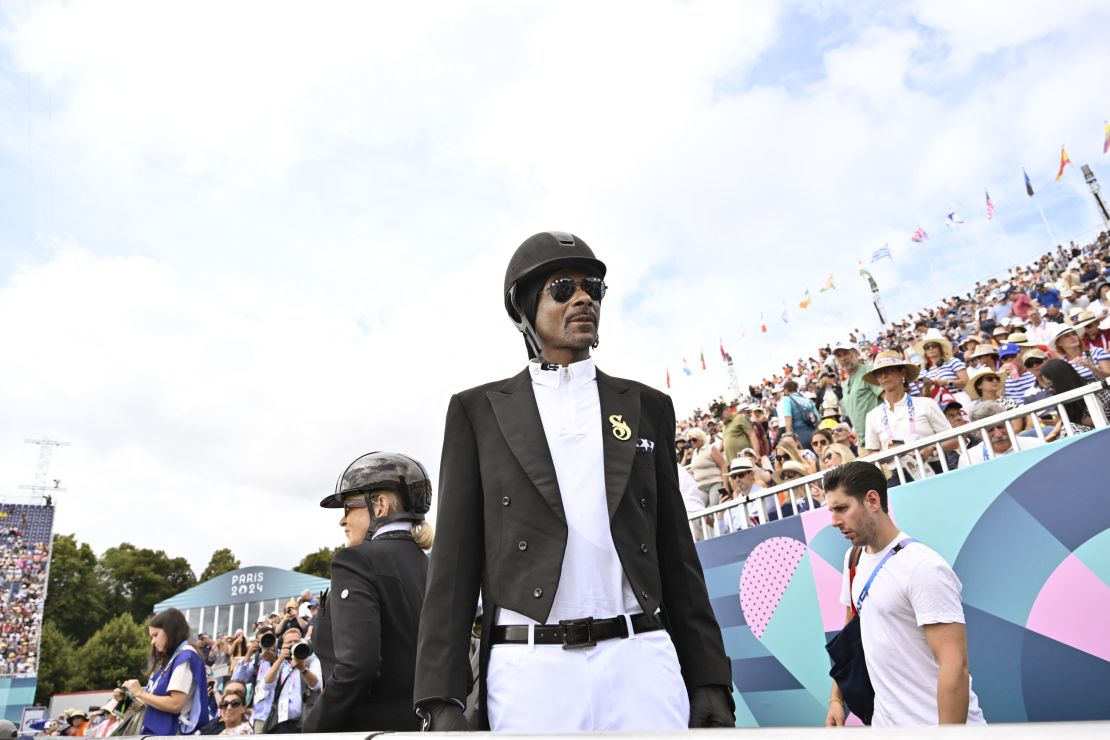 Rapper and record producer Snoop Dogg attended the equestrian's team dressage final on August 3 wearing a chic black and white ensemble fit for competition.