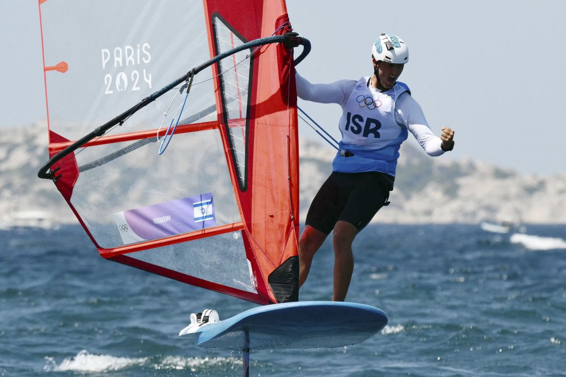 Reuveny celebrates after placing second in the semifinals of the men's IQFoil windsurfing event.