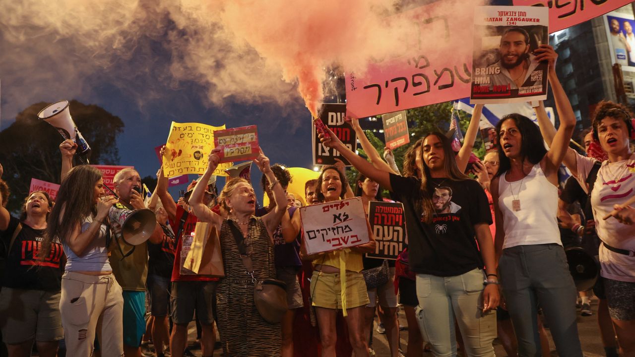 Supporters and relatives of Israelis held hostage by Palestinian militants in the Gaza Strip since October lift placards during a rally to demand their release in Tel Aviv on August 3, 2024.
