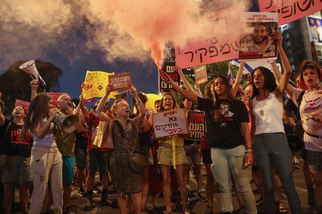 Supporters and relatives of Israelis held hostage by Palestinian militants in the Gaza Strip since October lift placards during a rally to demand their release in Tel Aviv on August 3, 2024.