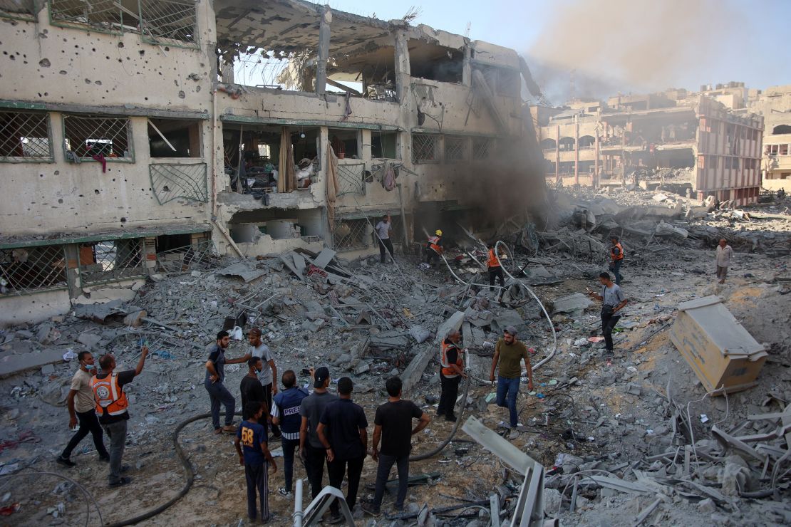 Palestinian rescuers extinguish a fire in a damaged building following Israeli bombardment which hit a school complex, including the Hamama and al-Huda schools, in the Sheikh Radwan neighbourhood in the north of Gaza City on August 3, 2024.