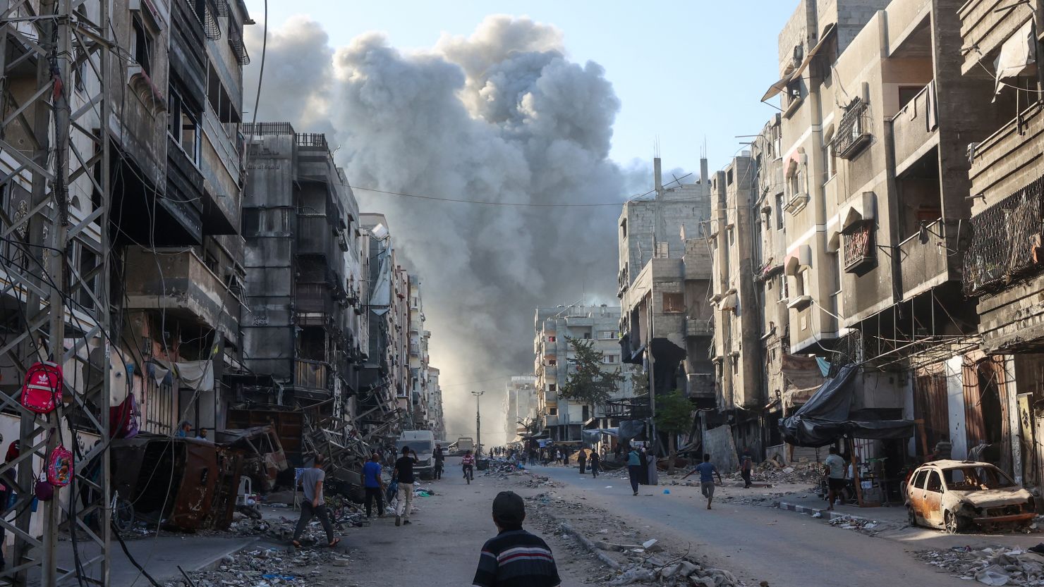 Palestinians rush towards a column of smoke billowing following Israeli bombardment which hit a school complex, including the Hamama and al-Huda schools, in the Sheikh Radwan neighbourhood in the north of Gaza City on August 3, 2024.