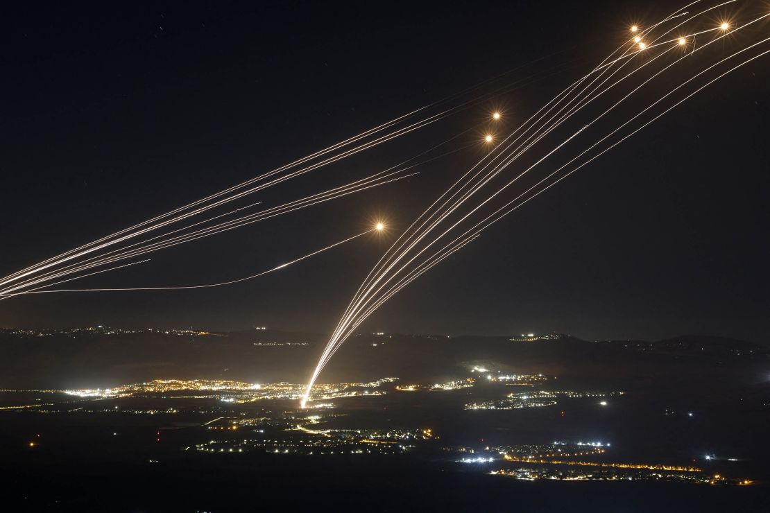 Rockets fired from southern Lebanon are intercepted by Israel's Iron Dome air defense system in northern Israel, August 4, 2024.