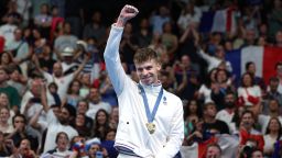 NANTERRE, FRANCE - JULY 31: Gold Medalist Leon Marchand of Team France celebrates on the podium during the Swimming medal ceremony after the Men's 200m Breaststroke Final on day five of the Olympic Games Paris 2024 at Paris La Defense Arena on July 31, 2024 in Nanterre, France. (Photo by Quinn Rooney/Getty Images)