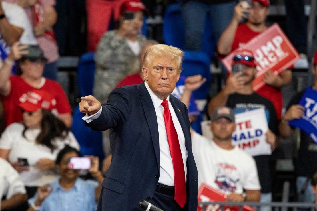 Former President Donald Trump points to the crowd as he leaves after a campaign rally at the Georgia State Convocation Center in Atlanta on August 3, 2024.