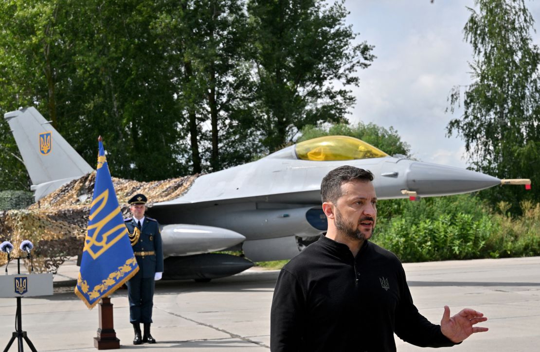 Zelensky speaks in front an an F-16 fighter jet on Ukrainian Air Forces Day at an undisclosed location, August 4, 2024.