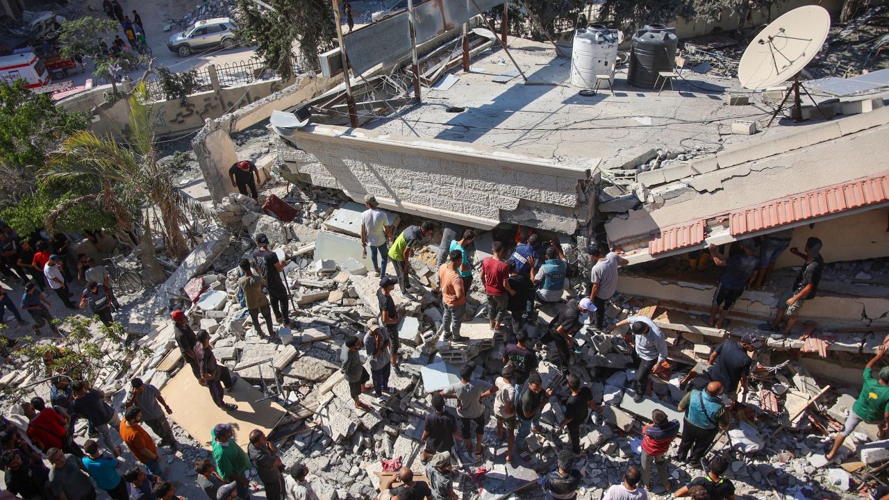 People and emergency crews look for survivors following Israeli bombardment on the Al-Nassr school that houses displaced Palestinians, West of Gaza city, on August 4, 2024, amid the ongoing conflict between Israel and the militant Hamas group. Gaza's civil defence agency said an Israeli strike hit two schools in Gaza City on August 4, killing at least 30 people, while the Israeli army reported it had struck Hamas command centres.