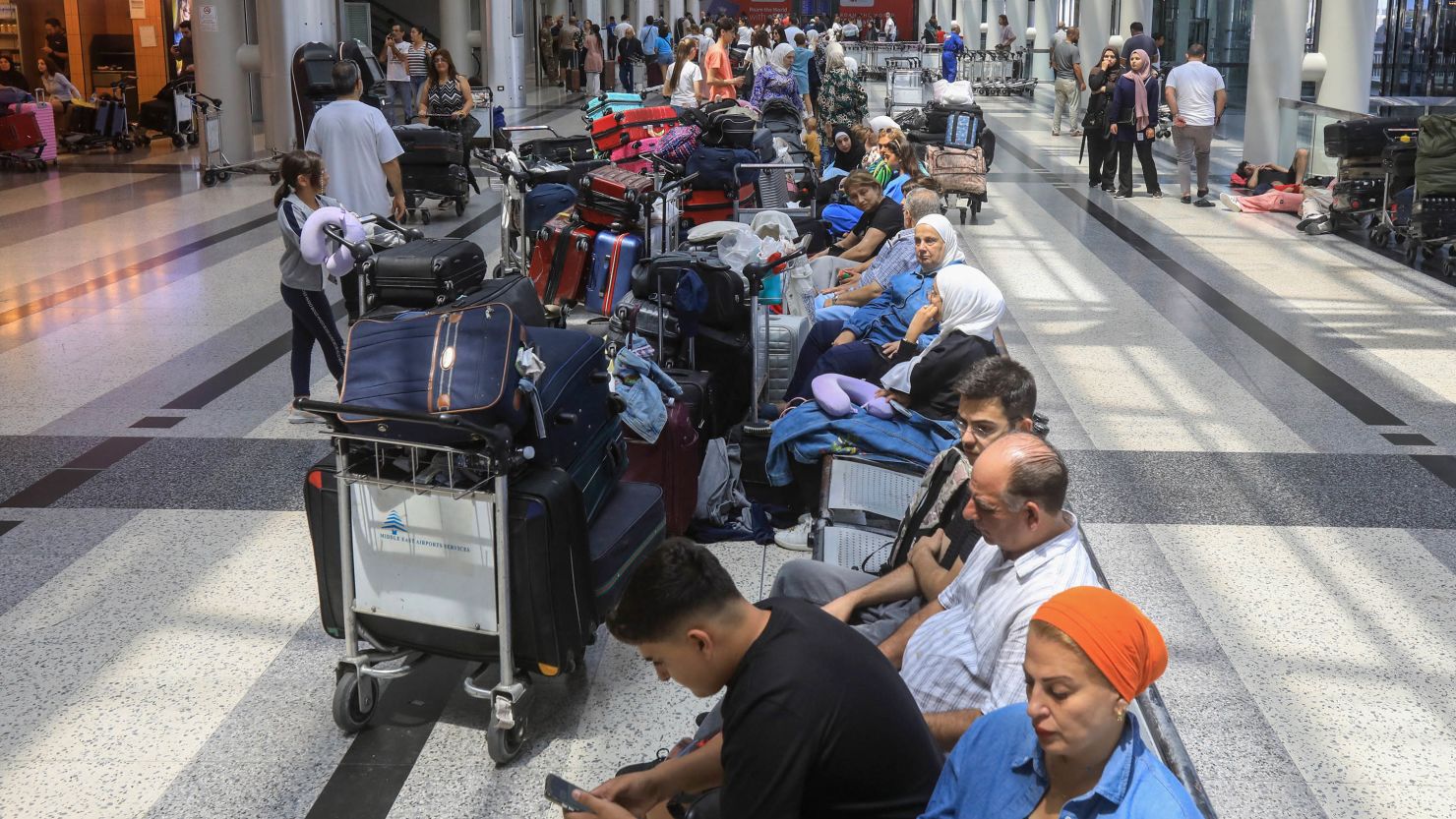 People await their flights at the Beirut airport's departure hall on Monday. Urgent calls grew for foreign nationals to leave Lebanon, which would be on the front line of a regional war, as Iran and its allies readied their response to high-profile killings blamed on Israel.