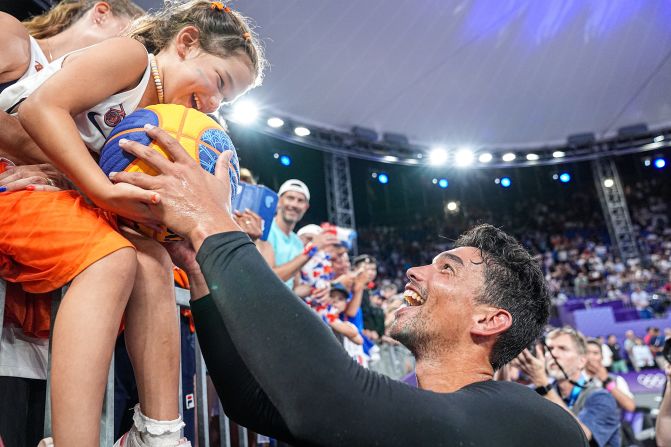 A fan receives a signed ball from Arvin Slagter of the Netherlands after <a >his 3x3 basketball team won gold</a> on August 5.