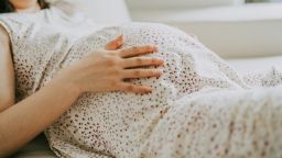 Close-up of pregnant woman's belly - stock photo