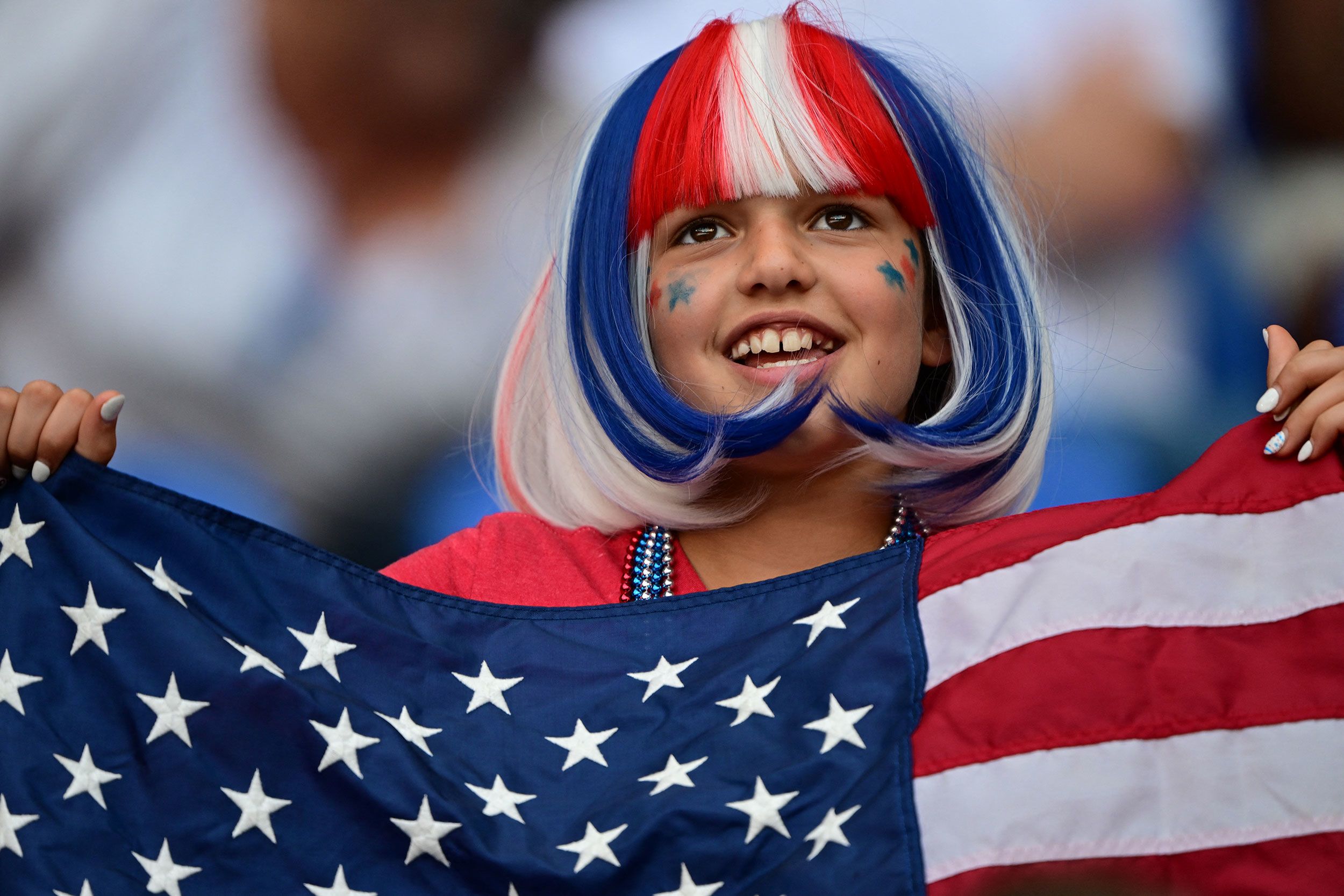 A young fan holds a US flag ahead of the women's soccer match against Germany on August 6.