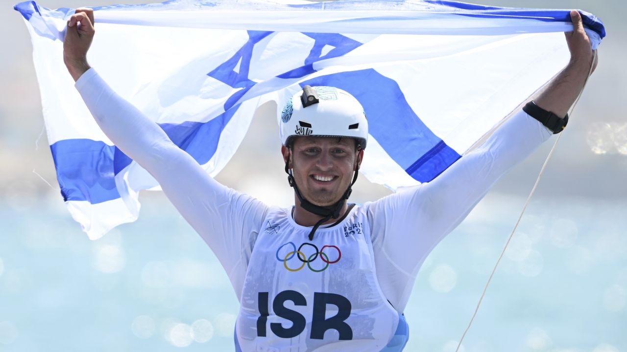 MARSEILLE, FRANCE - AUGUST 03: Tom Reuveny of Team Israel celebrates winning the Gold medal in the Men's Windsurf iQFoil class final on day eight of the Olympic Games Paris 2024 at Marseille Marina on August 03, 2024 in Marseille, France. (Photo by Clive Mason/Getty Images)