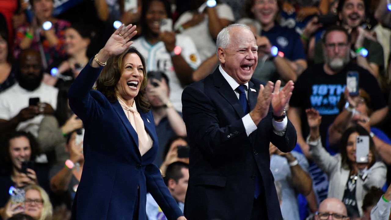 Vice President Kamala Harris and Minnesota Gov. Tim Walz greet supporters as they arrive at a rally in Philadelphia on August 6, 2024.