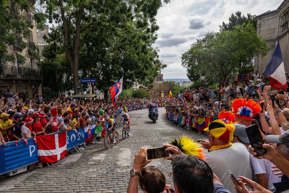 Evenepoel and Valenton Madouas of Team France pass through the Côte de la Butte Montmartre while fans cheers during the men's road race.