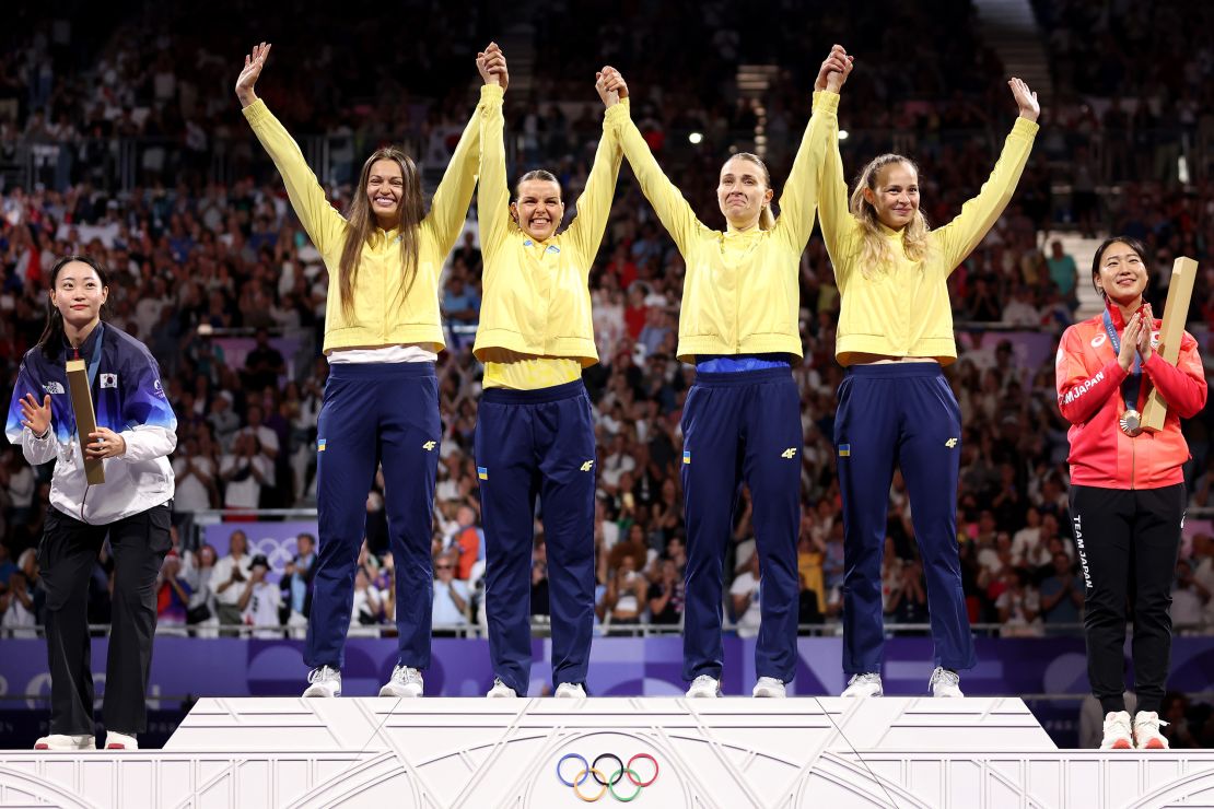 Gold medalists Olena Kravatska, Alina Komashchuk, Kharla and Yuliia Bakastova celebrate on the podium on August 3.