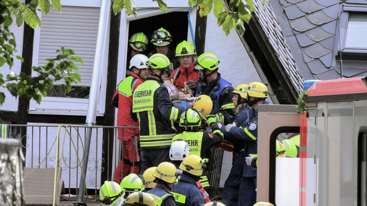 Video grab taken from a video footage shows rescuers helping a person out of a hotel that partly collapsed on August 7, 2024 in Kroev, western Germany,  killing one person and burying eight others. A floor in the hotel in Kroev, a town some 110 kilometres (68 miles) west of Frankfurt, collapsed for unknown reasons, police said in a statement. Of the 14 people inside at the time, five managed to get out. (Photo by NonStopNews / AFP) (Photo by -/NonStopNews/AFP via Getty Images)