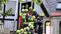 Video grab taken from a video footage shows rescuers helping a person out of a hotel that partly collapsed on August 7, 2024 in Kroev, western Germany,  killing one person and burying eight others. A floor in the hotel in Kroev, a town some 110 kilometres (68 miles) west of Frankfurt, collapsed for unknown reasons, police said in a statement. Of the 14 people inside at the time, five managed to get out. (Photo by NonStopNews / AFP) (Photo by -/NonStopNews/AFP via Getty Images)