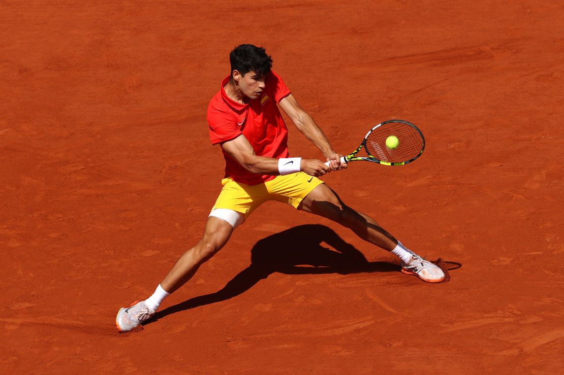 Alcaraz plays a backhand in the men's singles gold medal match.