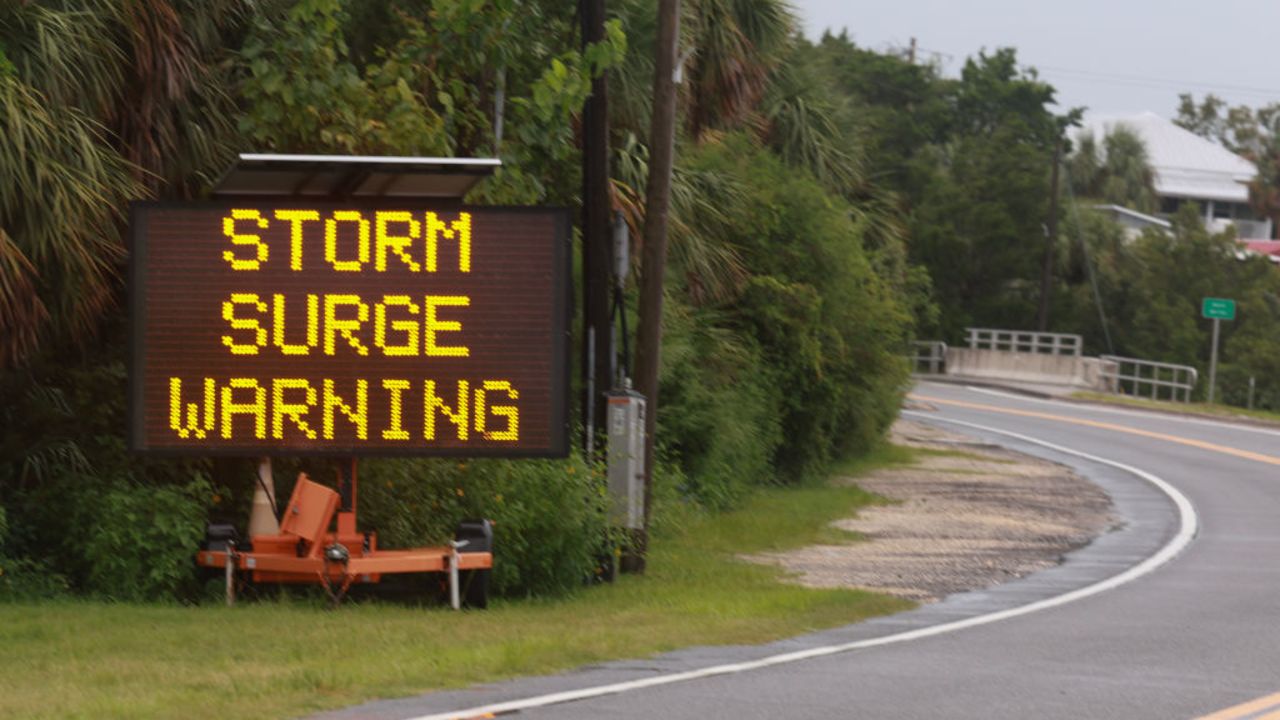 CEDAR KEY, FLORIDA - AUGUST 04: A sign warns of a storm surge before the possible arrival of Tropical Storm Debby, which is strengthening as it moves through the Gulf of Mexico on August 04, 2024 in Cedar Key, Florida. Forecasters say Tropical Storm Debby could become a hurricane as soon as Sunday evening, bringing rain storms and high winds along Florida’s west coast. (Photo by Joe Raedle/Getty Images)