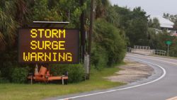 CEDAR KEY, FLORIDA - AUGUST 04: A sign warns of a storm surge before the possible arrival of Tropical Storm Debby, which is strengthening as it moves through the Gulf of Mexico on August 04, 2024 in Cedar Key, Florida. Forecasters say Tropical Storm Debby could become a hurricane as soon as Sunday evening, bringing rain storms and high winds along Florida’s west coast. (Photo by Joe Raedle/Getty Images)