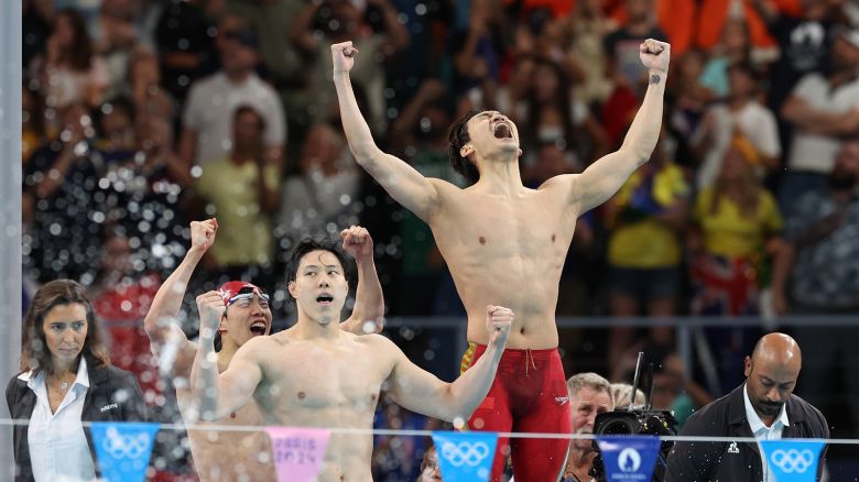 China's swim team celebrates victory in the men's 4x100m medley relay final at the Paris Olympics on August 4, 2024 in Nanterre, France.