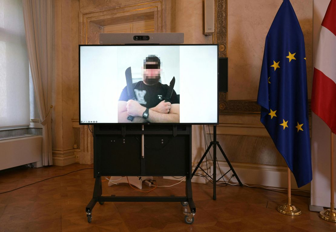 A screen displays a photo of a man arrested in connection with a suspected terror plot that caused the cancellation of the Vienna leg of a tour by American mega-star Taylor Swift.