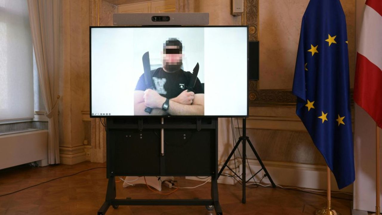 A screen displays a photo of a man arrested in connection with an Islamist attack plot that caused the cancellation of the Vienna leg of a tour by American mega-star Taylor Swift, on the sidelines of a press conference on August 8, 2024 at the Foreign Ministy in Vienna, Austria. A 19-year-old IS sympathiser was planning a suicide attack at a Taylor Swift concert in Vienna designed to kill many people, the intelligence agency said. (Photo by ROLAND SCHLAGER / APA / AFP) / Austria OUT (Photo by ROLAND SCHLAGER/APA/AFP via Getty Images)