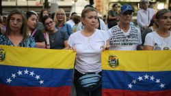 People hold Venezuelan flags during a vigil called by the opposition demanding freedom for political prisoners arrested during protest following the contested re-election of Venezuelan President Nicolas Maduro in Caracas, August 8, 2024. Venezuela's opposition warned of a potential mass exodus of migrants if President Nicolas Maduro remains in power following his contested reelection, with the US calling on the strongman not to arrest protest leaders. (Photo by YURI CORTEZ / AFP) (Photo by YURI CORTEZ/AFP via Getty Images)