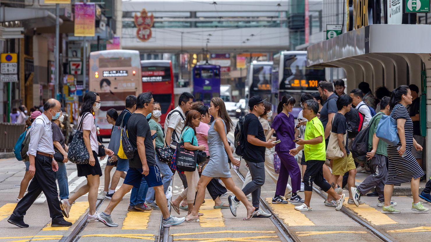 Pedestrians cross a street in Hong Kong on June 25, 2024.