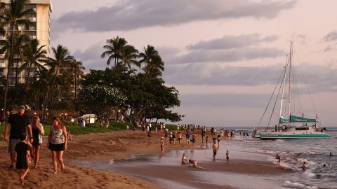 LAHAINA, HAWAII - AUGUST 05: People gather on Kaanapali Beach, a popular tourist destination, on August 5, 2024 near Lahaina, Hawaii. In June, Maui saw a 22 percent decline in visitor arrivals and 27 percent decrease in visitor spending compared to 2023, according to the state Department of Business, Economic Development and Tourism. August 8 marks the one-year anniversary of the Maui wildfires which killed 102 people and devastated the historic community of Lahaina in West Maui. (Photo by Mario Tama/Getty Images)