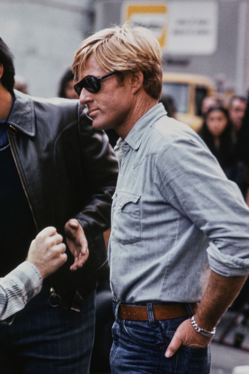 Off-duty, Redford — shown here in 1975 — stuck to his Canadian tuxedo's, blacked out aviators and western-style leather belts.