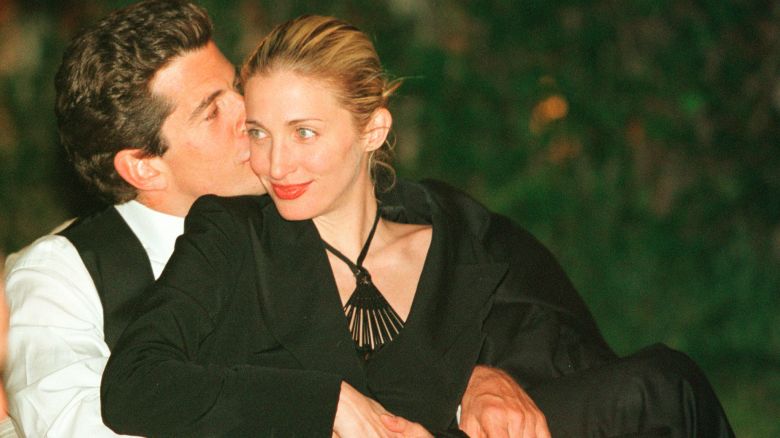 WASHINGTON - MAY 1:  (FILE PHOTO) (ITALY OUT) John F. Kennedy, Jr. editor of George magazine, gives his wife Carolyn Bessette Kennedy a kiss on the cheek during the annual White House Correspondents dinner May 1, 1999 in Washington, D.C. July 16, 2003 marks the four year anniversary of the plane crash which killed Kennedy, his wife and sister-in-law. (Photo by Tyler Mallory/Getty Images)
