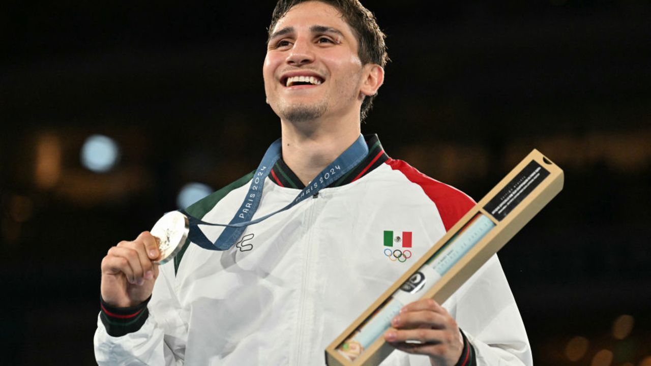 Silver medallist Mexico's Marco Alonso Verde Alvarez celebrates on the podium during the medal ceremony for the men's 71kg final boxing category during the Paris 2024 Olympic Games at the Roland-Garros Stadium, in Paris on August 9, 2024. (Photo by MOHD RASFAN / AFP) (Photo by MOHD RASFAN/AFP via Getty Images)