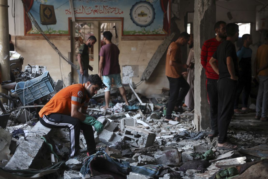 People check the damage inside a school used as a temporary shelter for displaced Palestinians in Gaza City, following an Israeli strike on August 10.