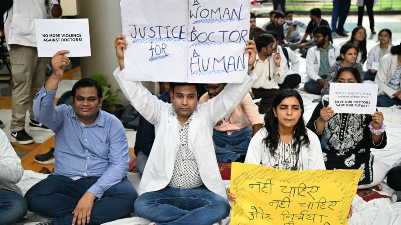 Practicing doctors and medical staff display placards as they take part in a protest against the incident of rape and murder of a young medic in Kolkata, during a demonstration held at a government hospital in New Delhi on August 12, 2024. Indian doctors in government hospitals across several states halted elective services "indefinitely" on August 12 to protest the rape and murder of a young medic. (Photo by Money SHARMA / AFP) (Photo by MONEY SHARMA/AFP via Getty Images)