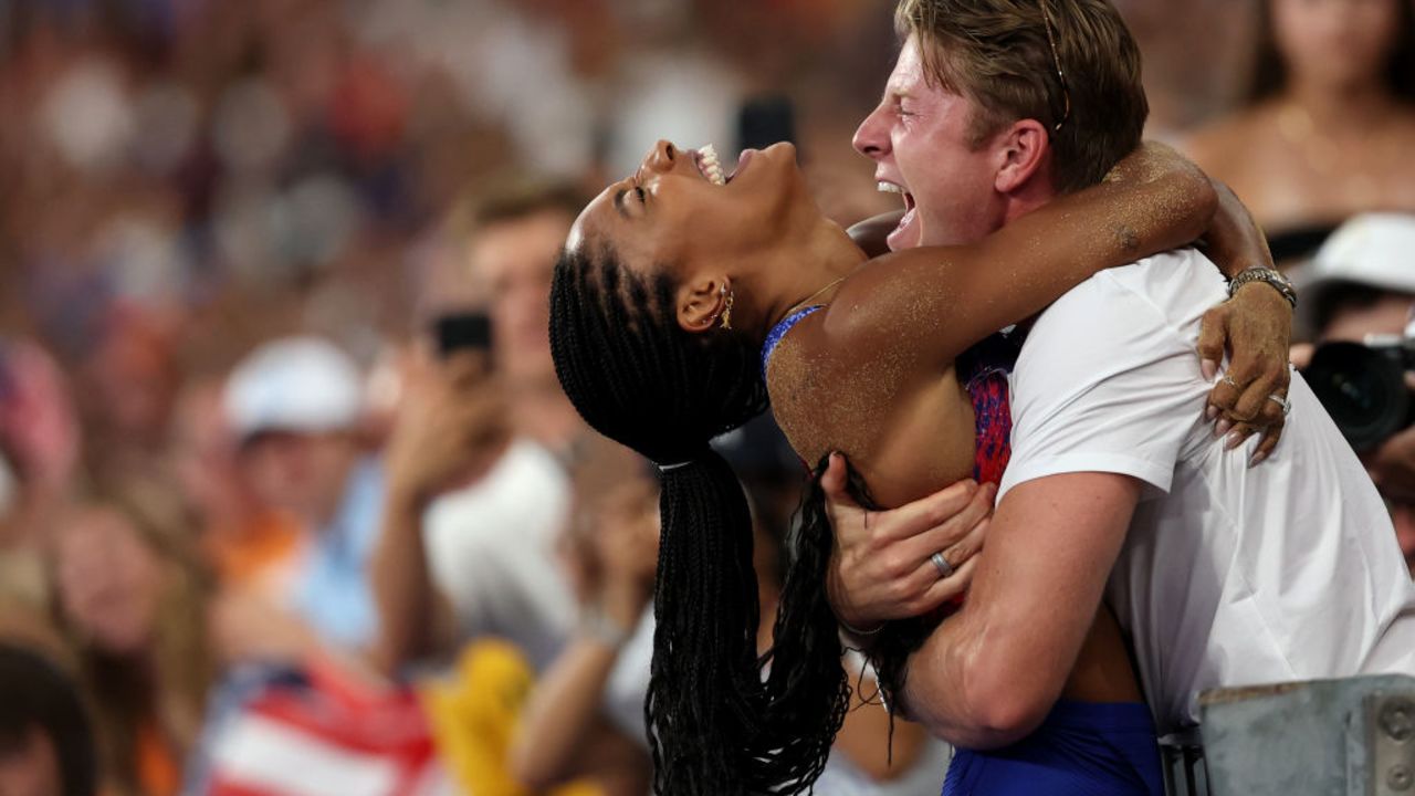 PARIS, FRANCE - AUGUST 08: Tara Davis-Woodhall of Team United States celebrates with her husband Hunter Woodhall after winning the gold medal in the Women's Long Jump Final on day thirteen of the Olympic Games Paris 2024 at Stade de France on August 08, 2024 in Paris, France. (Photo by Patrick Smith/Getty Images)